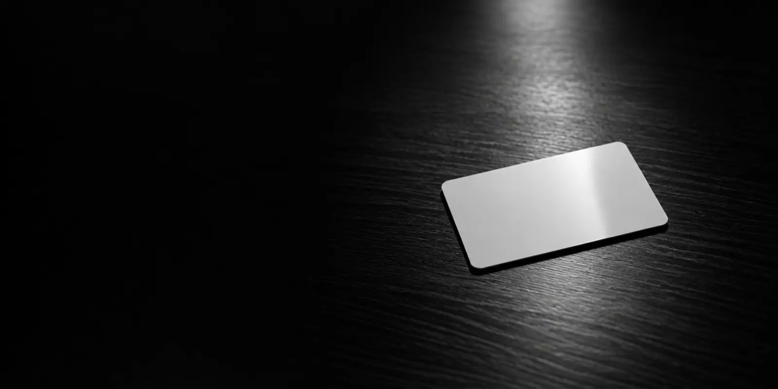 A blank access card lies on a dark desk, lit by a spotlight, symbolising access that was never revoked.